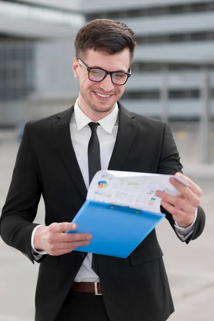 smiley business man checking clipboard